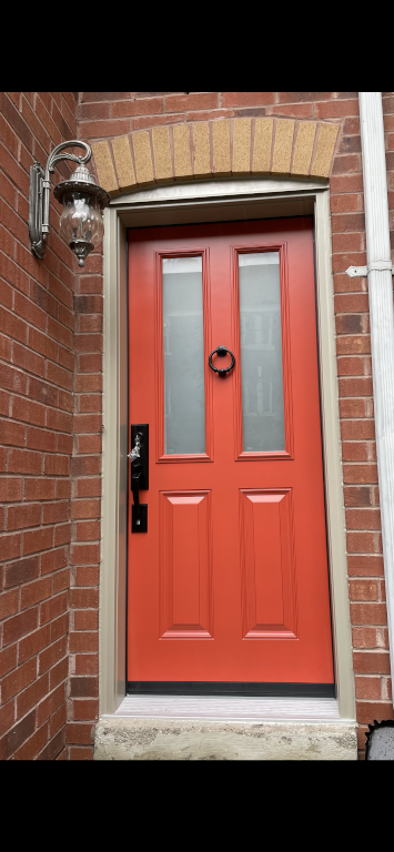 red entry door with two windows