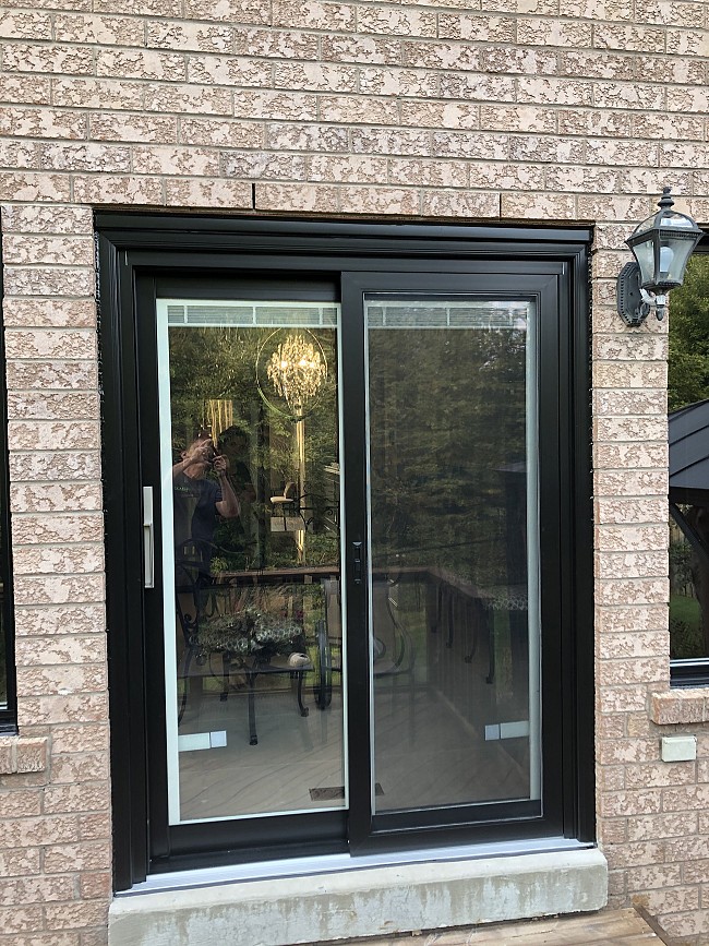 black vinyl patio door with wide frame