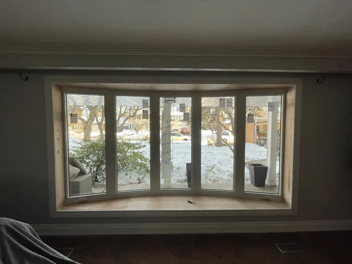 Interior view of a five-panel bow window looking out on a snowy yard, bow window installation in Vaughan