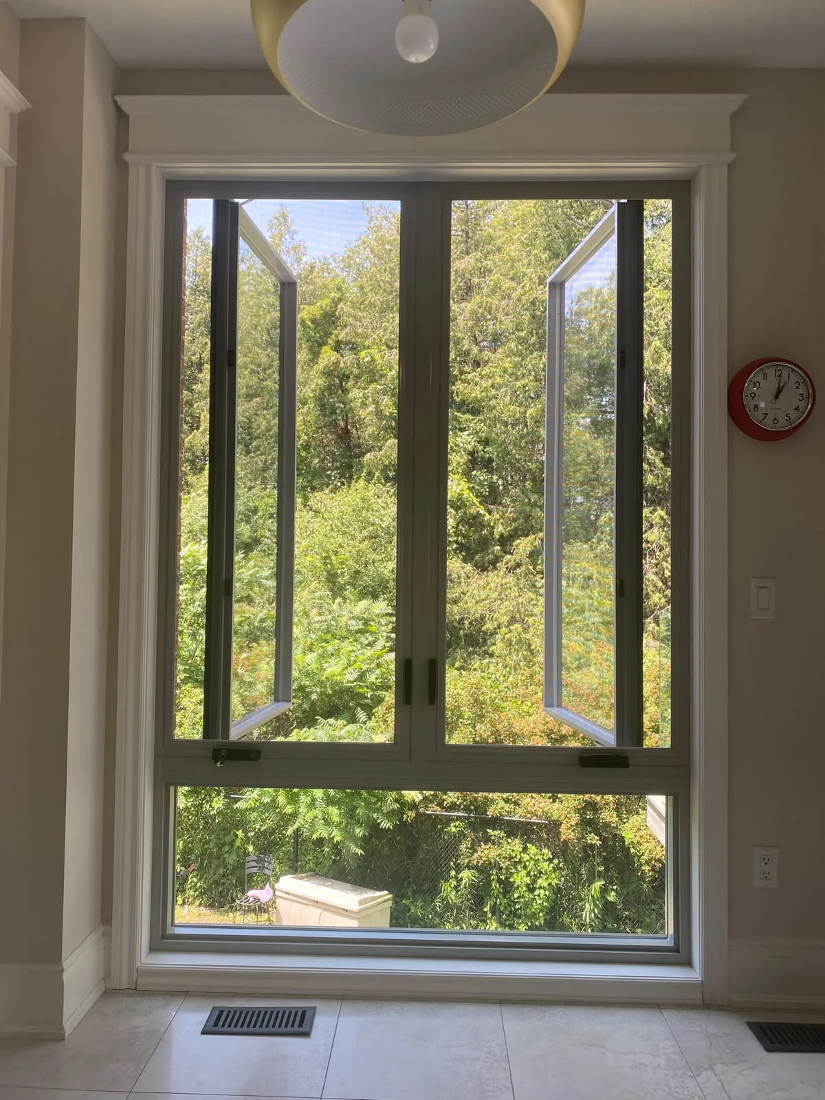 Black-frame casement windows opened outward above a fixed pane in a bright kitchen, casement window installation in Vaughan