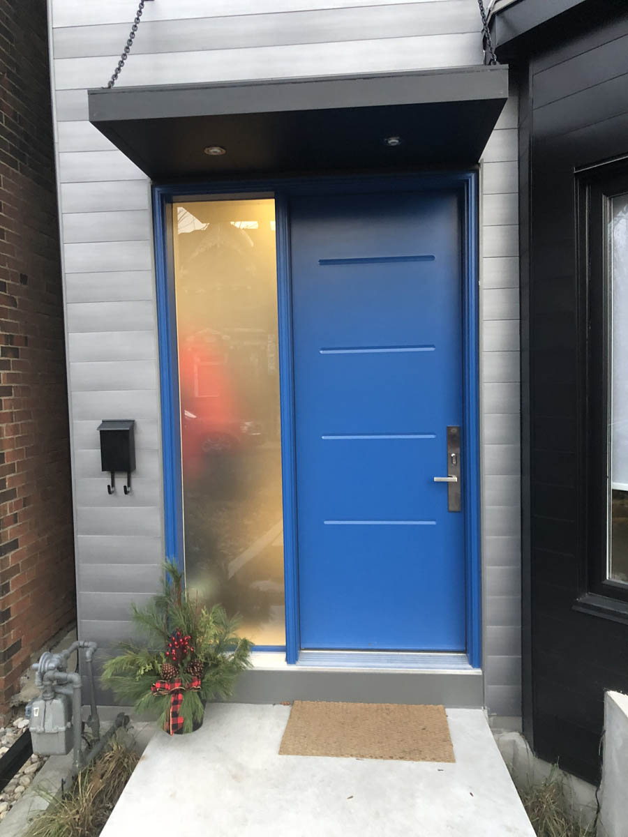 a-modern-townhome-with-blue-entry-door-installed-in-toronto-canada